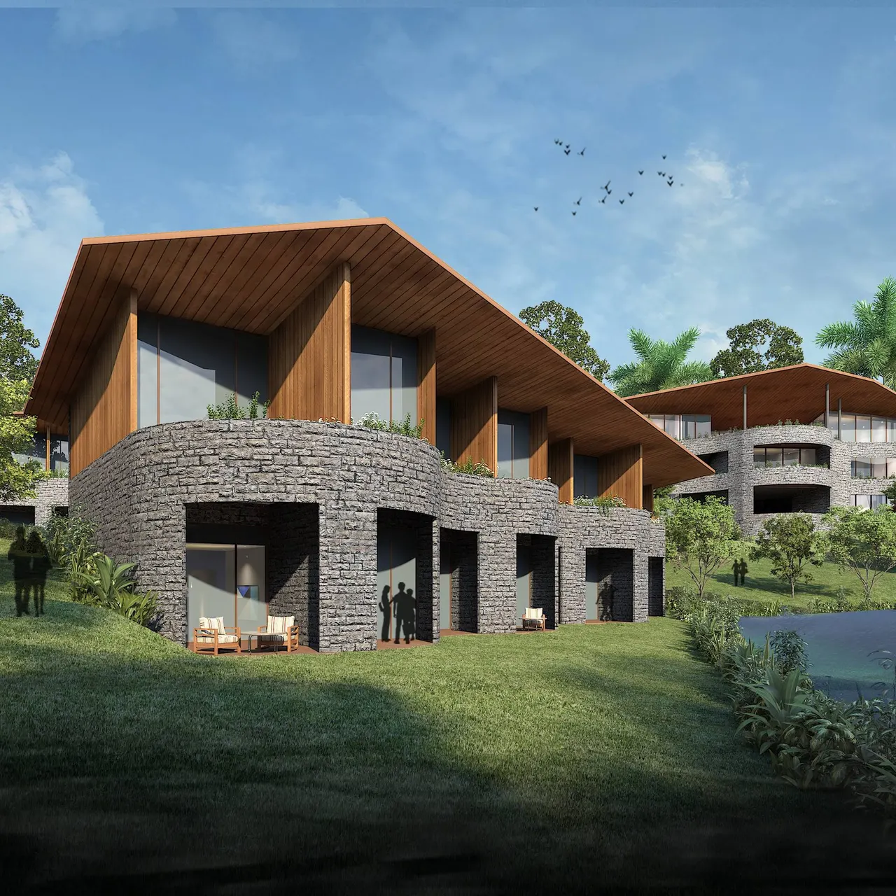 Hillside pool villas at KAMAH Resort Coorg with stone bases and timber-clad roofs overlooking Coorg's Western Ghats