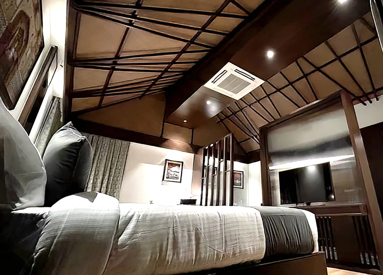 Cottage suite interior at Regenta Resort & Spa Pushkar with vaulted ceiling and warm wood detailing